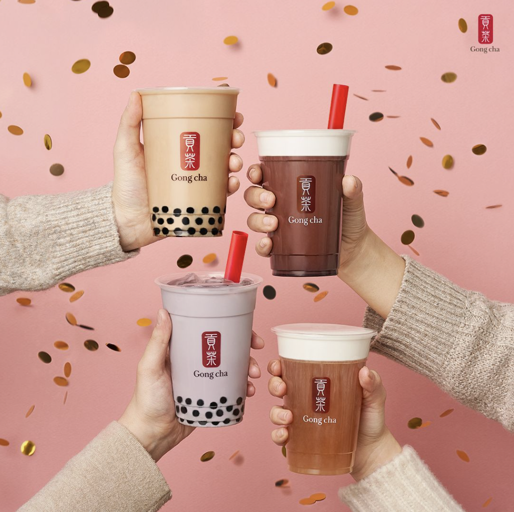 Photo of Gong cha employee holding a tea cup with both hands